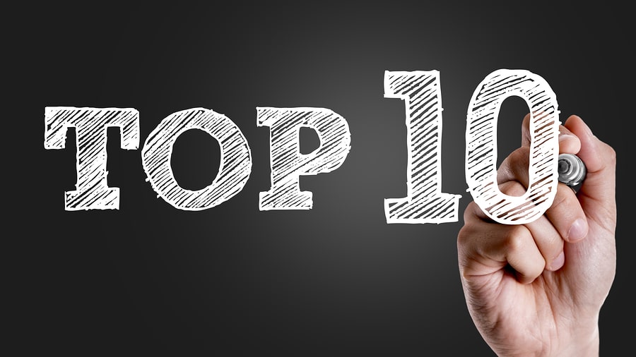 A hand drawing the words "Top 10" in white marker on a black background