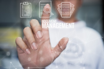 A close up of a finger pressing a touch screen icon labelled Document Management