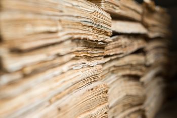 Stacks of old, yellowed paper documents