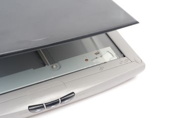 An office scanner with the lid open on a white background