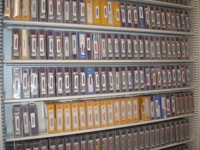 A shelving unit full of labelled tapes