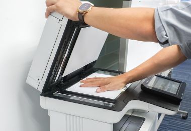 Close up of business person using scanner in an office