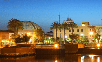 A pier at night with buildings in the background. Stockton Pier.